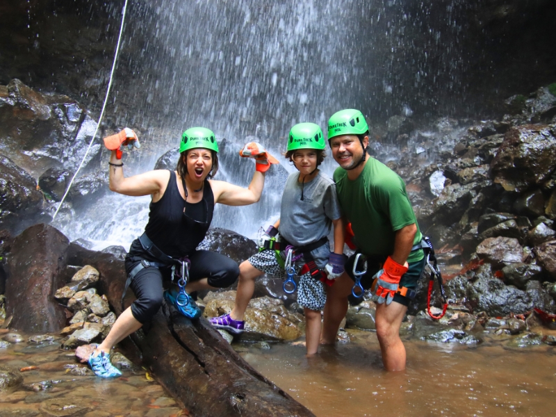 Family celebrating after a canyoning waterfall adventure with Pure Trek in La Fortuna, Costa Rica.