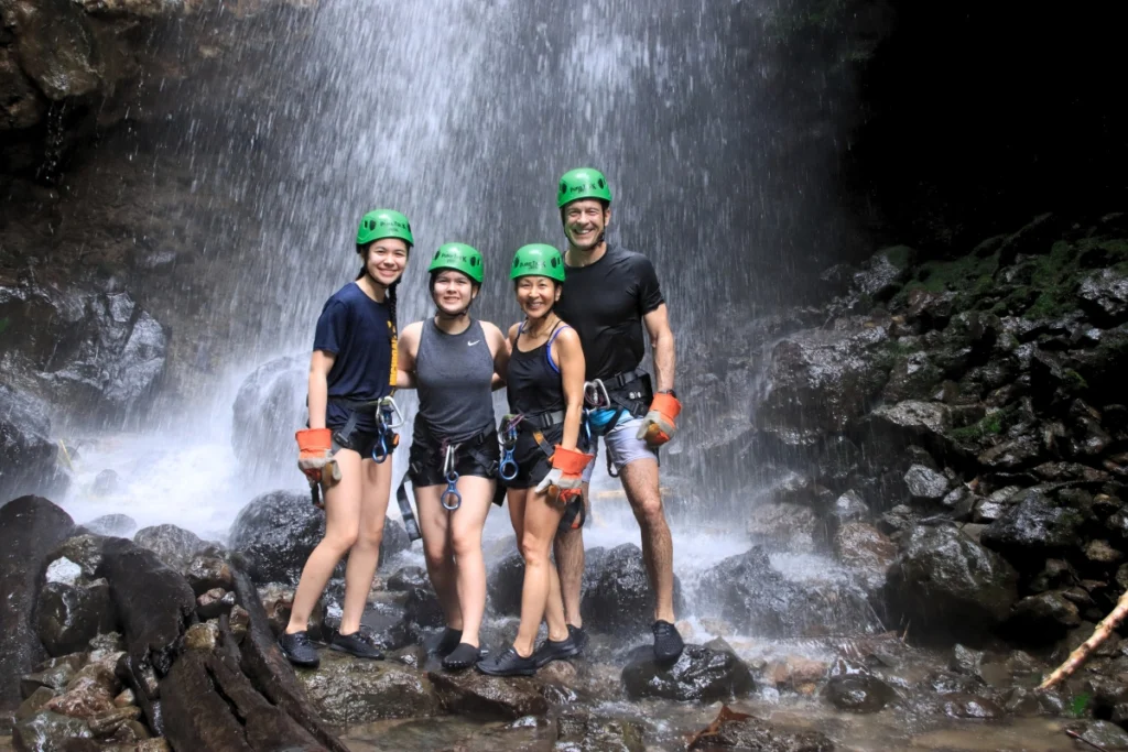 Group of guests enjoying a canyoning tour at a waterfall in Arenal, Costa Rica.