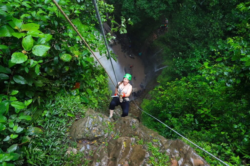 woman waterfall rappelling rainforest falls arenal costa rica canyoning adventure